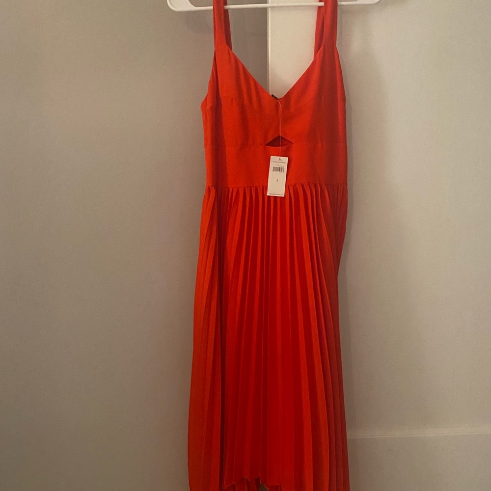Beautiful coral red color midi with peekaboo at the chest, pleated bottom. NWT
